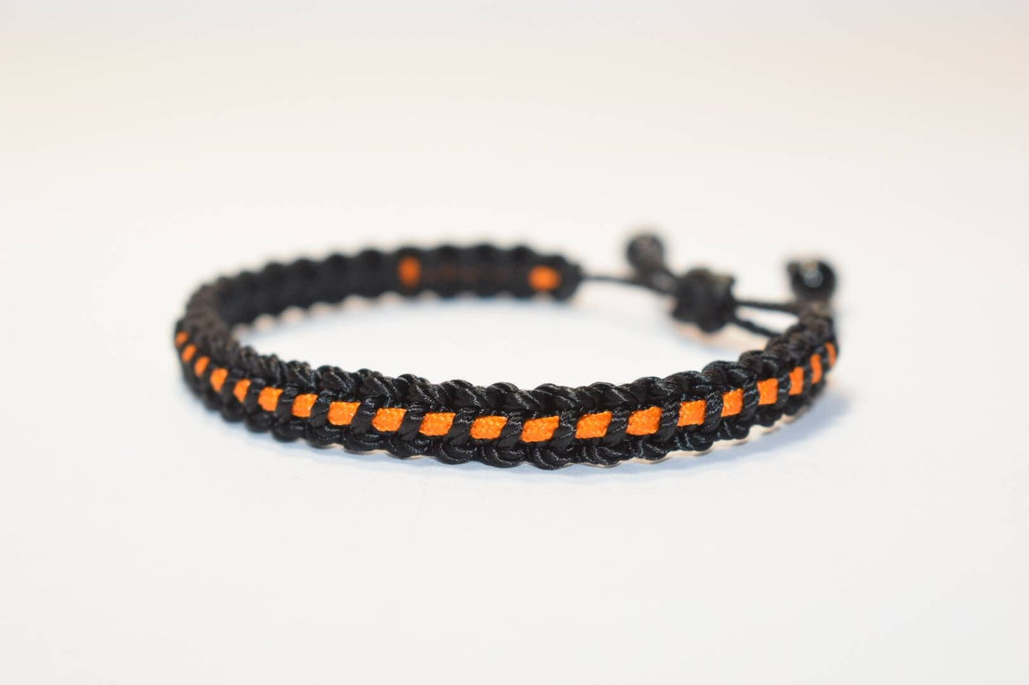 Black with orange line bracelet -Black braided bracelet with a thin orange Line, adjustable wristband -new -handmade awareness bracelet