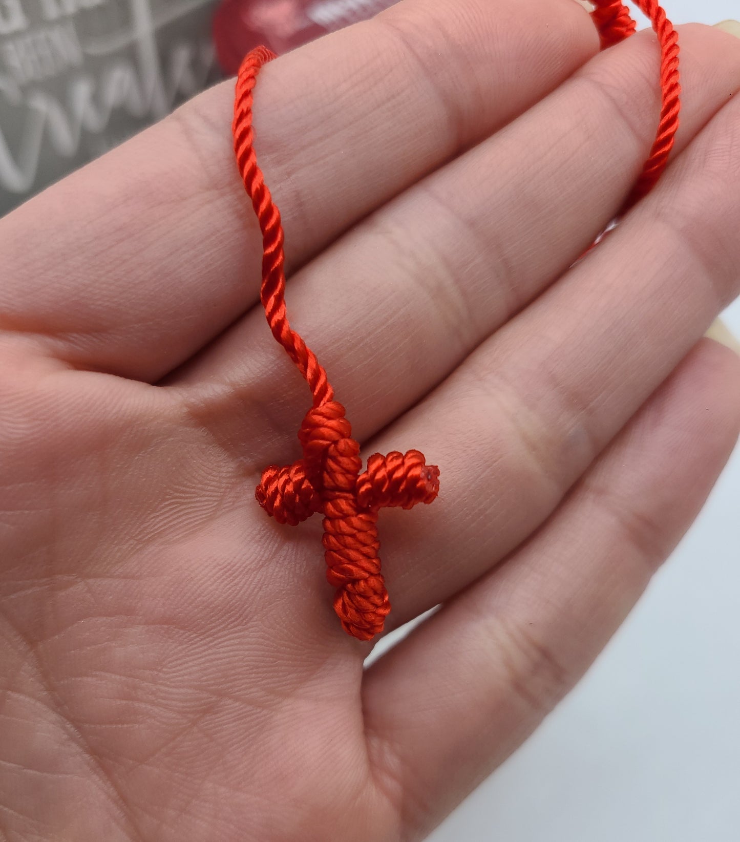Red string cross bracelet
