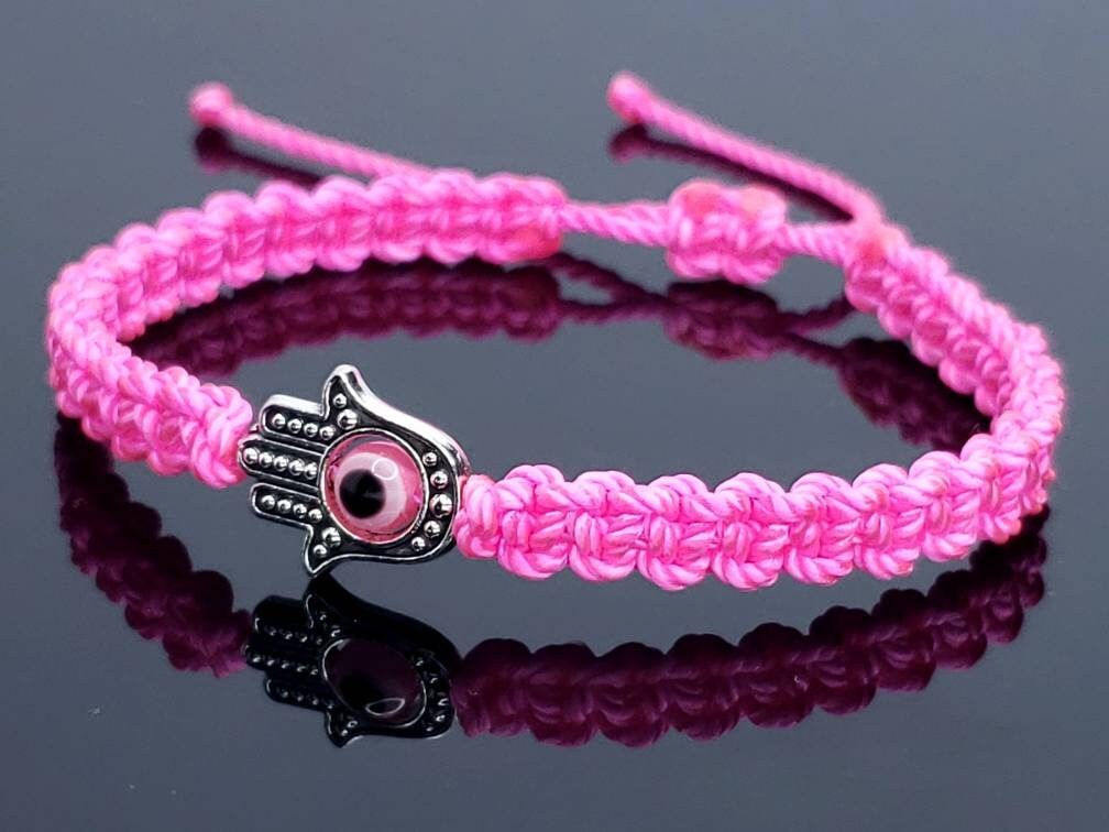 Hamsa Hand neon pink bracelet with an evil eye for protection & good luck braided neon pink string wristband with a silver color hamsa hand