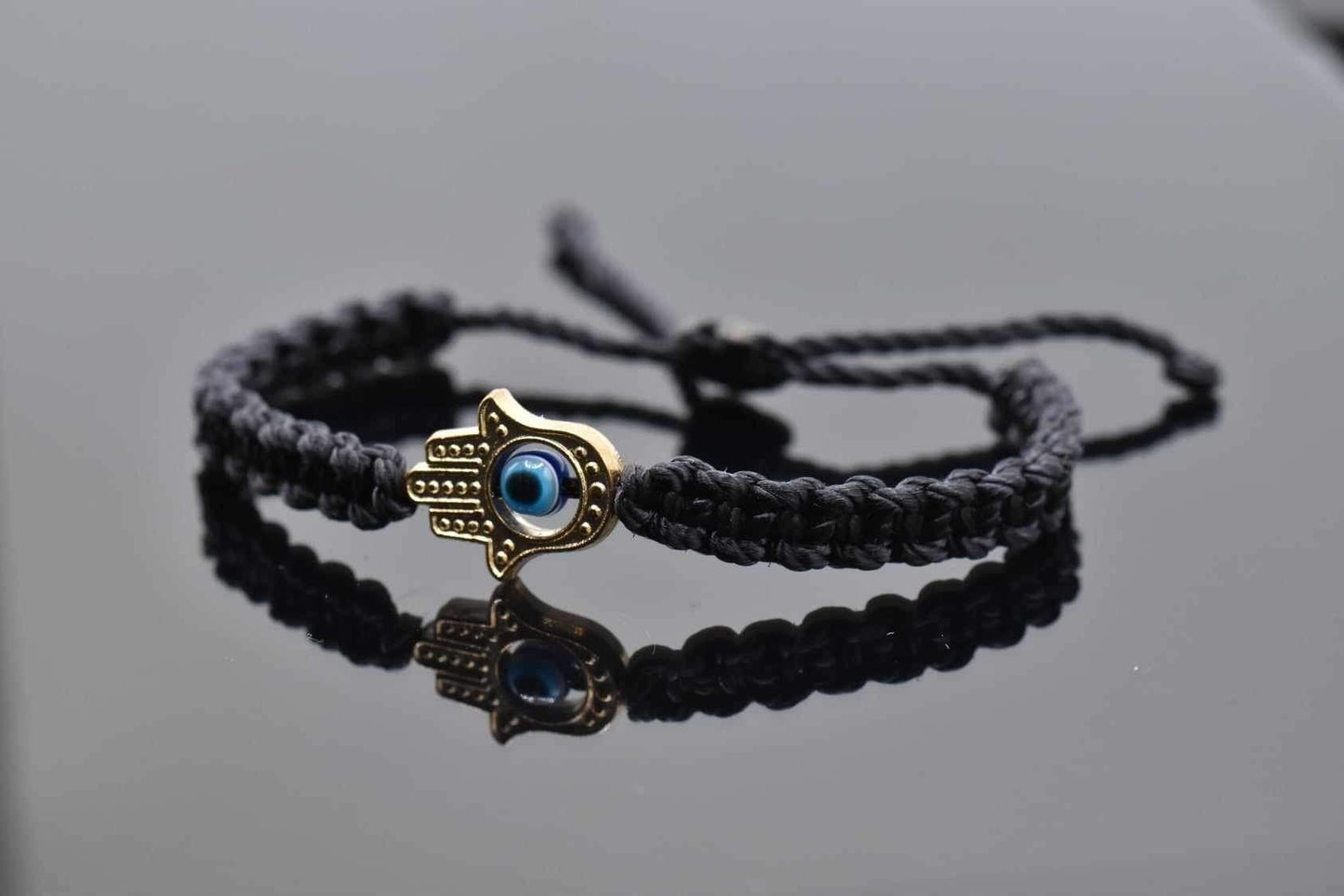 Hamsa hand bracelet with an evil eye for protection & good luck, braided black string wristband with a gold color hamsa hand adjustable