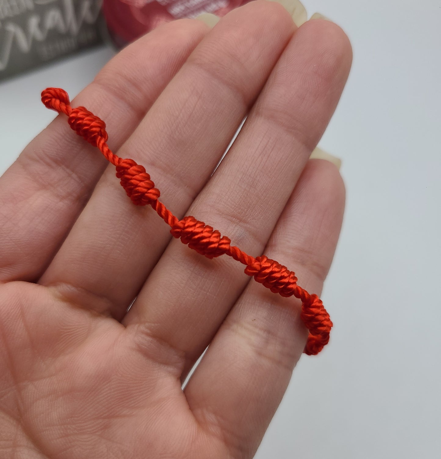 Red string cross bracelet