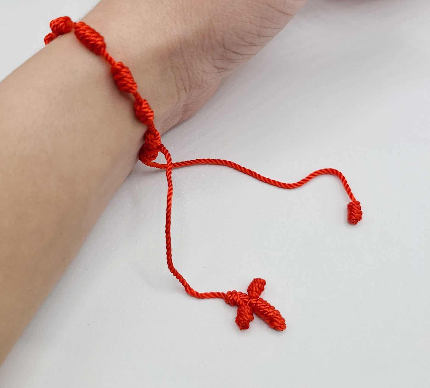 Red string cross bracelet